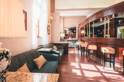 a lobby with couches and a bar in a restaurant at Carlton in Prague
