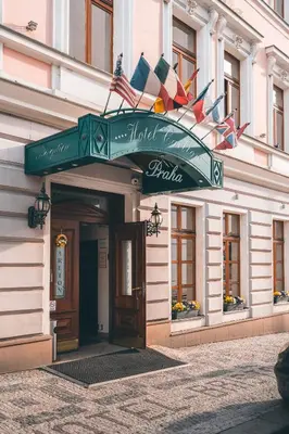 a building with a green sign on the front of it at Carlton in Prague