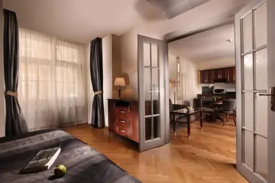 a living room with a couch and a dining room at Elysee Hotel in Prague