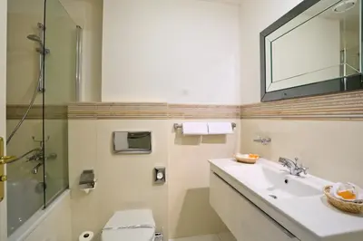 a bathroom with a sink and a toilet and a mirror at Elysee Hotel in Prague