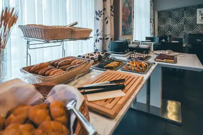 a buffet with bread and pastries on a table at Elysee Hotel in Prague