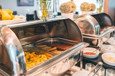 a buffet line with hot dogs and other food at Elysee Hotel in Prague