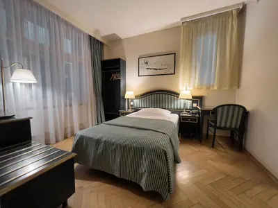 a hotel room with a bed and a desk at Elysee Hotel in Prague