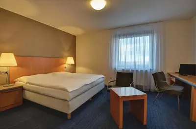 a hotel room with a bed and a desk at Hotel Henrietta in Prague