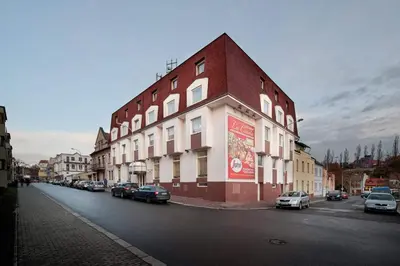 a building with cars parked on the side of a street at Hotel Henrietta in Prague