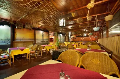 a restaurant with tables and chairs in a room at Hotel Henrietta in Prague