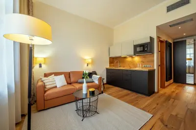 a living room with a couch and a table at Design Merrion Residence in Prague