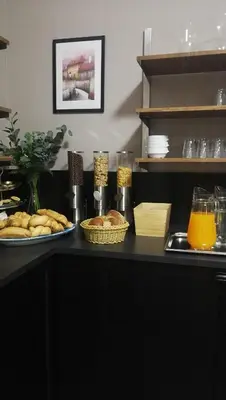 a plate of pastries and other pastries on a table at Hotel Tulipan Pruhonice in Pruhonice