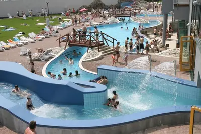 a group of people in a large swimming pool at Hotel Tulipan Pruhonice in Pruhonice