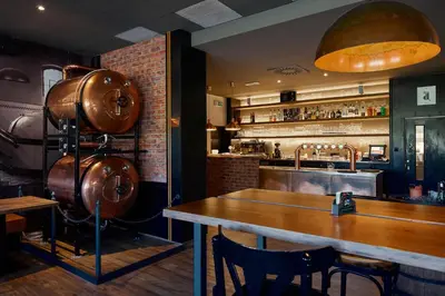 a bar with a wooden table in a restaurant at Hotel Tulipan Pruhonice in Pruhonice