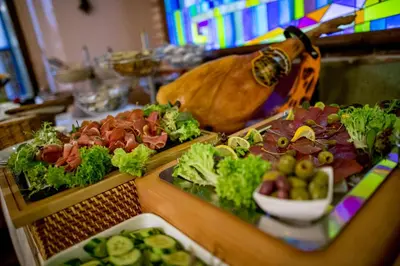 a table topped with trays of different types of food at Hotel Salvator in Prague