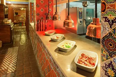 three bowls of food on a counter in a restaurant at Hotel Salvator in Prague