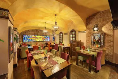 a restaurant with tables and chairs in a room at Hotel Salvator in Prague
