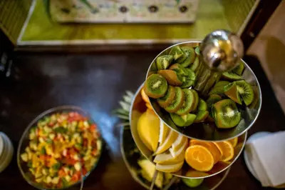 a table with a bowl of food and a plate of fruit at Hotel Salvator in Prague