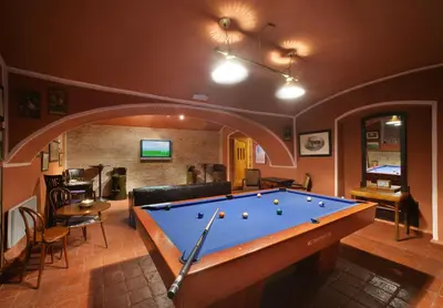 a living room with a pool table in it at Hotel Salvator in Prague