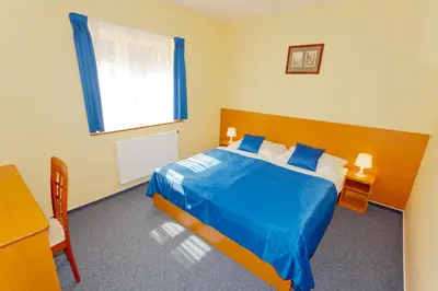 a bedroom with a blue bed and a window at Adeba Hotel in Prague