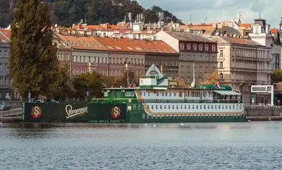 a large green and white boat on the water at Admiral Botel in Prague