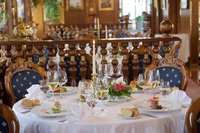 a table with plates of food and wine glasses at Admiral Botel in Prague