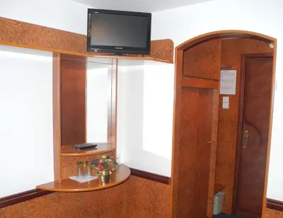 a room with a tv on top of a wall at Admiral Botel in Prague