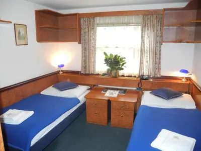 a room with two beds and a window at Admiral Botel in Prague