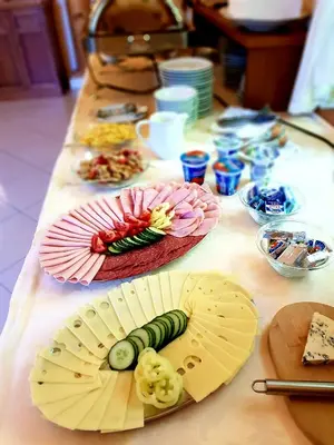 a long table in a room with food on it at Hotel Nosal in Prague