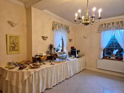 a dining room with a table and blue chairs at Hotel Nosal in Prague