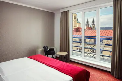 a hotel room with two beds and a window at Astoria Hotel in Prague