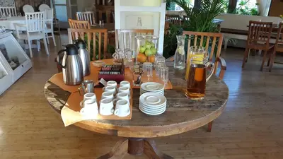 a wooden table with drinks and cups on top of it at Villa St. Tropez in Prague