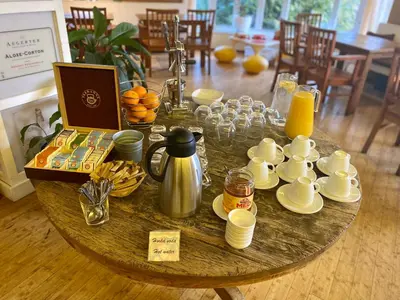 a table with cups and cups of coffee and juice at Villa St. Tropez in Prague