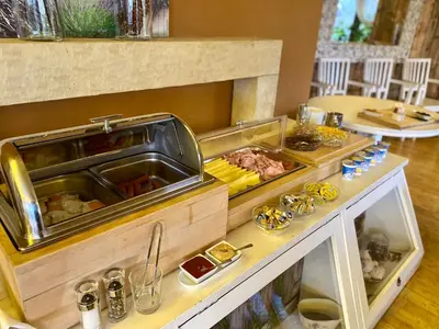 a buffet with meat and other food on a table at Villa St. Tropez in Prague