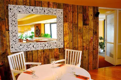 a dining room with a table and a mirror at Villa St. Tropez in Prague