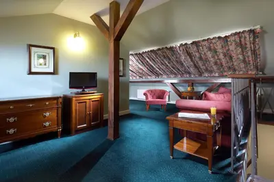 a living room with a couch and a tv at Hotel Liberty in Prague