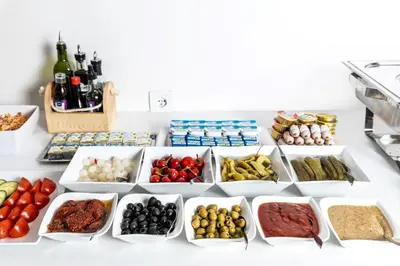 a table filled with different types of food at My Hotel Apollon in Prague