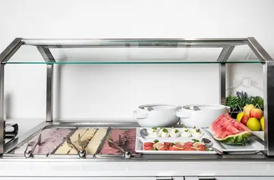 a glass display case with food on a plate at My Hotel Apollon in Prague