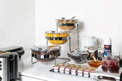 a kitchen counter with three tiers of food at My Hotel Apollon in Prague