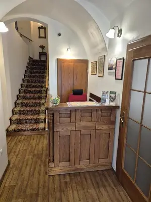 a room with a staircase and a counter with a door at Hotel Lippert in Prague