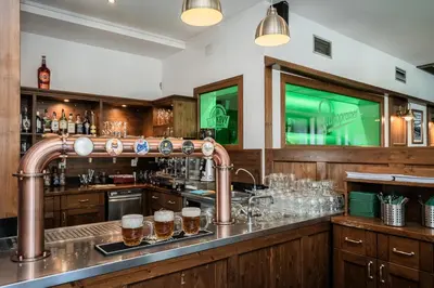 a bar with a copper piping in a room at Hotel Globus in Prague