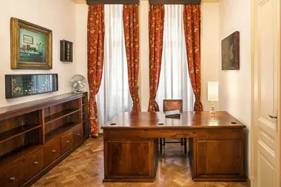 a bedroom with a bed and a desk and a mirror at BHG Apartments Prague in Prague