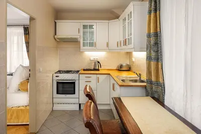 a bedroom with a bed with a lamp on a night stand at BHG Apartments Prague in Prague