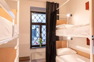 a room with bunk beds with a window at Sir Toby's Midtown in Prague