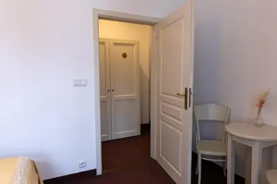 a small room with a door and a table and chair at Sir Toby's Midtown in Prague