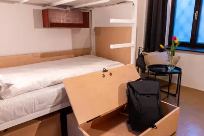 a room with a bed and a desk and a chair at Sir Toby's Midtown in Prague