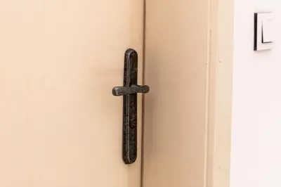 a black door handle on a white door at Sir Toby's Midtown in Prague
