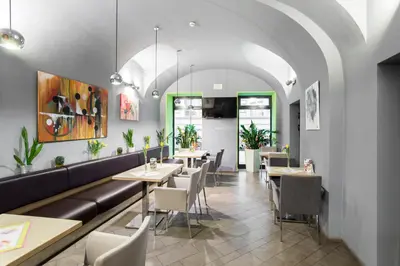 a restaurant with tables and chairs and a couch at Hotel Páv in Prague