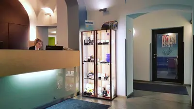 a woman sitting at a counter in a store at Hotel Páv in Prague