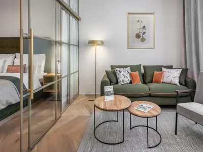 a living room with a couch and a table at The Botanist by Adrez in Prague