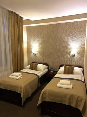 a hotel room with two beds with towels on them at U Stare Pani - At the Old Lady Hotel in Prague