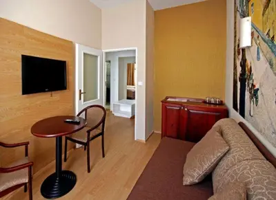 a living room with a couch and a table at U Stare Pani - At the Old Lady Hotel in Prague