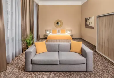 a hotel room with a bed and a couch at Hotel 