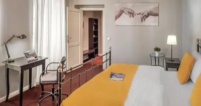 a bedroom with a bed and a desk and a chair at Hotel 